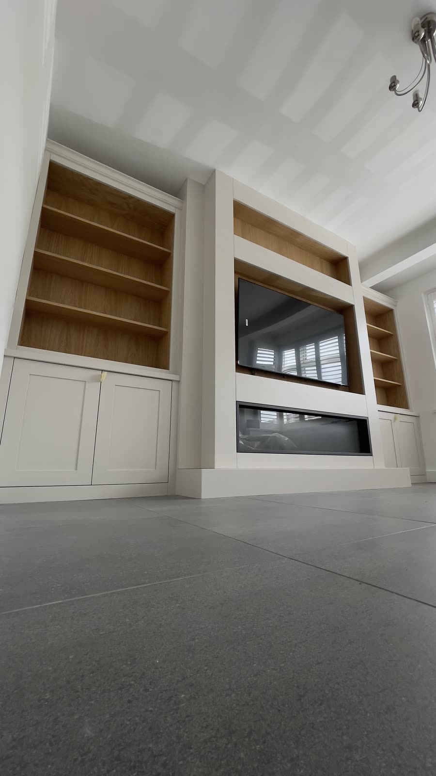 Media wall with TV, fireplace recess and oak shelving