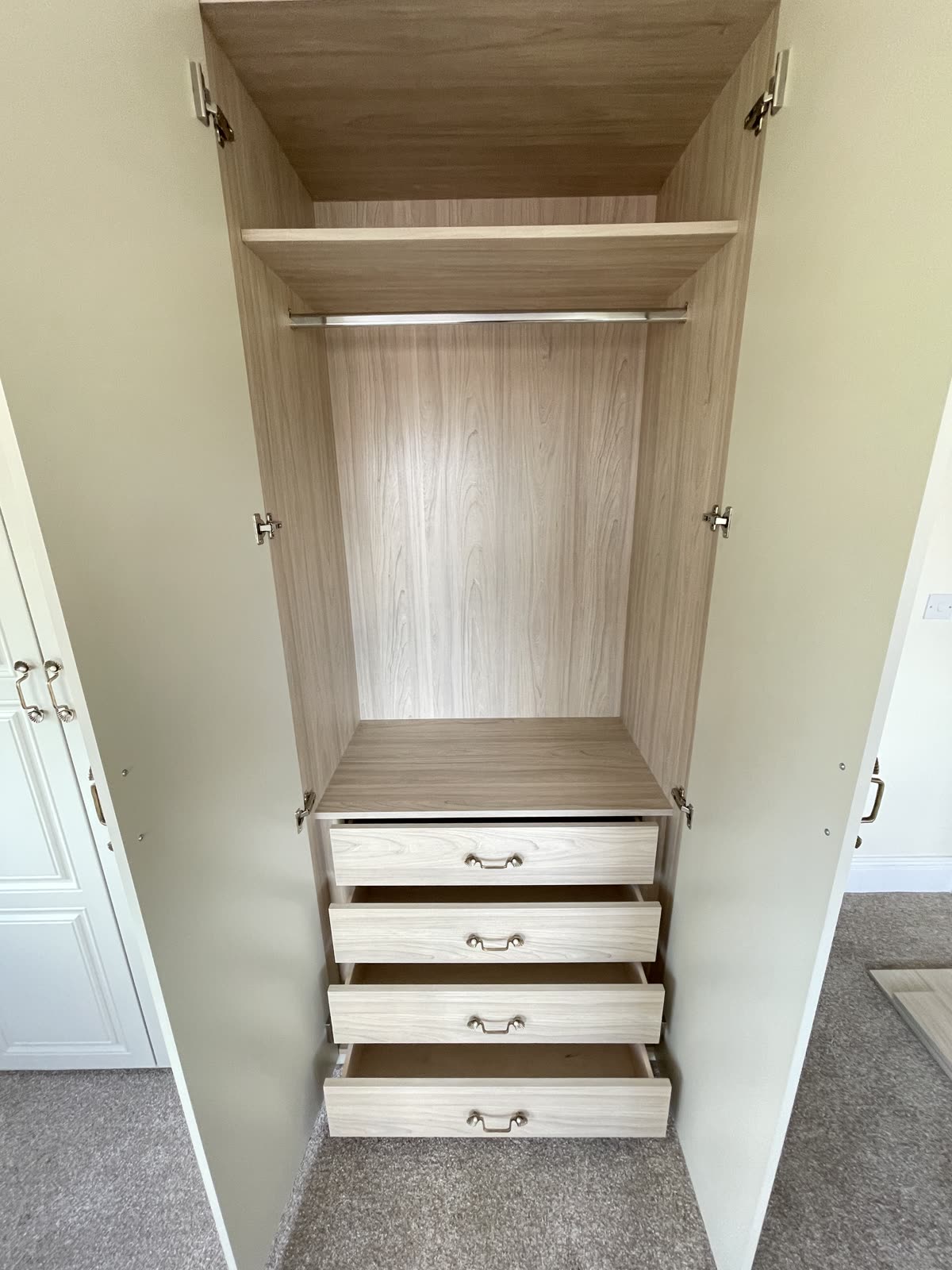 Wardrobe interior with wood finish and pull-out drawers
